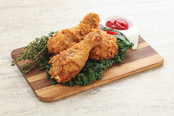 Fried chicken drumsticks with tomato sauce