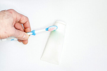 Female hand with tooth brush on white background