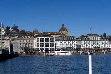 Cityscape of Luzern with lake Lucerne in the foreground on a sunny winter day. Photo taken February 9th, 2022, Lucerne, Switzerland.