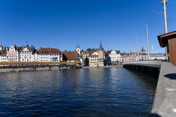 Fototapeta na wymiar Medieval old town of Luzern with famous covered wooden Chapel Bridge (German: Kapellbrücke) and stone water tower on a sunny winter day. Photo taken February 9th, 2022, Lucerne, Switzerland.