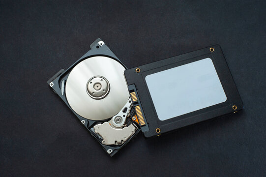 Macro view of an HDD head resting on a disk platter and its reflection