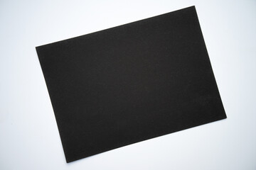 A black gloomy sheet of paper on a white background.  A dark blank sheet for text.