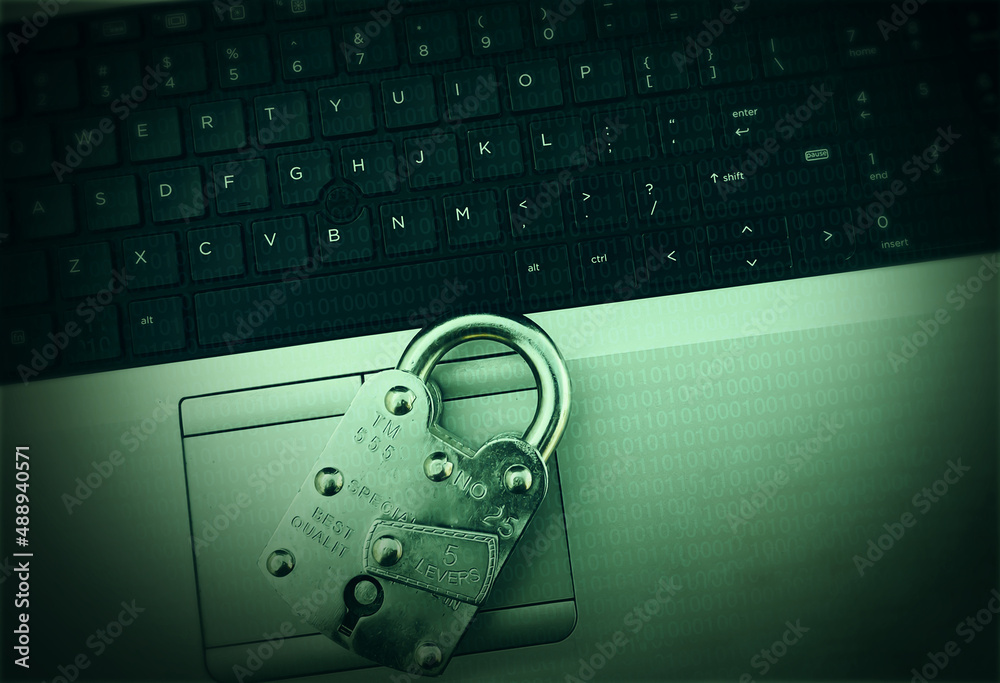 Poster green hacking concept background with vintage lock and keyboard of laptop. binary numbers green data
