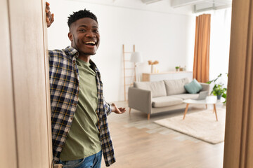 Happy African American Man Opening Door Smiling Standing At Home