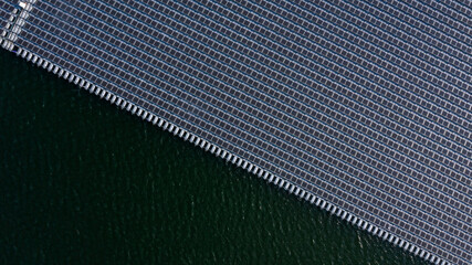 Aerial view floating solar cell power plant with solar cell generate the electric on the lake, Floating solar panels and cell platform on the water ecological energy, Alternative renewable energy. © Kalyakan