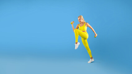 Fototapeta na wymiar Young Woman Exercising With Dumbbells Isolated On Blue Background