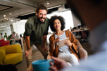 Portrait of creative business people team working together and smiling in office.