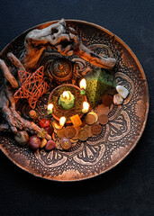 Witch altar with candles, different old coins, stone runes, pentacle on dark table background.  Magic for attracting money, wealth. witchcraft money esoteric ritual. occultism concept. top view