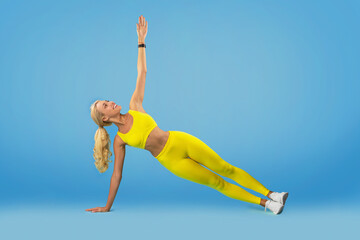 Smiling Young Woman Doing Side Plank Balance Exercise