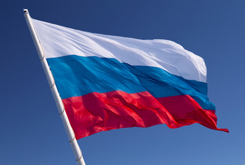 Naklejka na ściany i meble Russian flag on a background blue sky