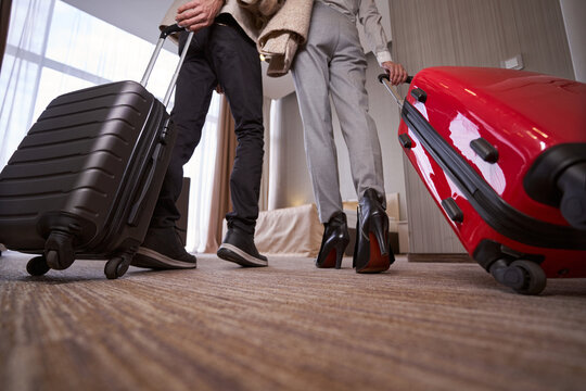 Man and woman with baggage in hotel room