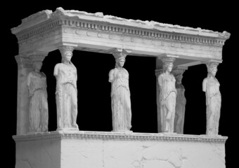 The Caryatid porch of the Erechtheion Temple in Athens isolated on black background with clipping...