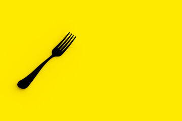 Fork is black on yellow background. Isolated object. Horizontal image. 3D image. 3D rendering.