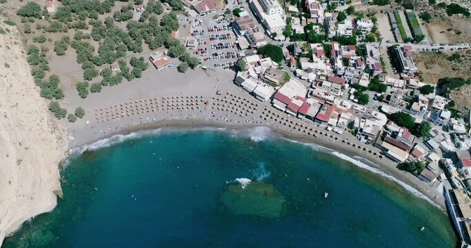 Beautiful view from a drone flying over the beach and bay in Matala Crete Greece