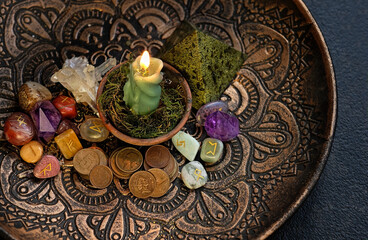 Witch altar with candles, different old coins, stone runes, crystals on dark table background. Magic for attracting money, wealth. witchcraft money esoteric ritual. occultism concept. top view