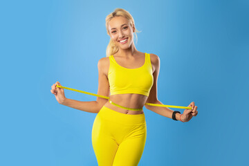Smiling Young Woman Measuring Waist Holding Tape