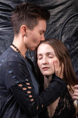 Photo of two kissing lesbian women with snakes