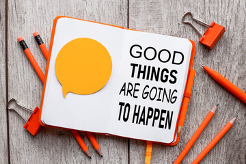 Good Things Are Going To Happen. text on an open notepad. orange notepad.