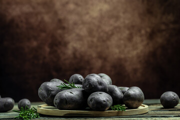 Raw purple sweet potato food . Fresh potatoes in an old sack on wooden background. Batata potato. vegan food ingredient. banner, menu, recipe place for text, top view