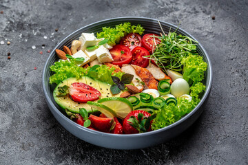 Ketogenic diet food, chicken fillet, quinoa, avocado, avocado, feta cheese, quail eggs, strawberries, nuts and lettuce. healthy meal concept, top view