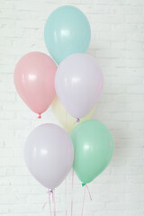 multi coloured baloons on background of white wall