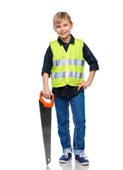 Fototapeta premium building, carpentry and profession concept - happy smiling little boy in protective helmet and safety vest with saw over white background