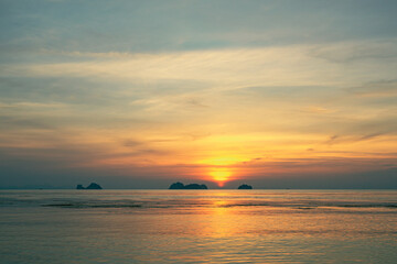 Obraz premium Spectacular colorful sunset over sea and islands on a summer evening. Sun setting in the sea.