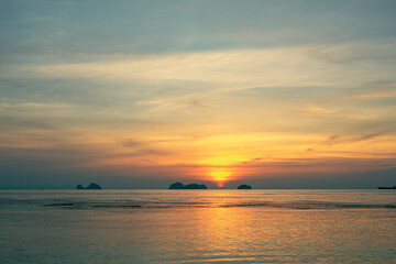Spectacular colorful sunset over sea and islands on a summer evening. Sun setting in the sea.
