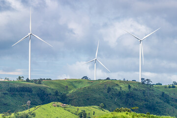 Three wind turbines farm on mountain in rural area. The clean energy system in Khao Kho District, Phetchabun, Thailand, Southeast Asia.