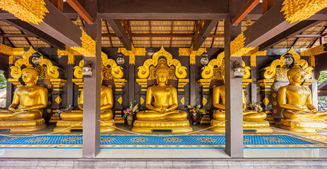Open-sided wooden pavilion of five Buddha image statues at Wat Phra That Doi Phra Chan. It is Thai Buddhist temple on the top hill of Doi Phra Chan mountain in Mae Tha, Lampang, Thailand.