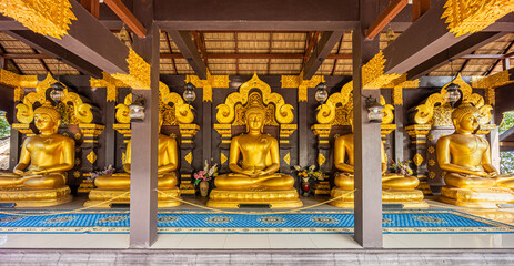 Open-sided wooden pavilion of five Buddha image statues at Wat Phra That Doi Phra Chan. It is Thai...