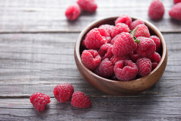 Fresh raspberry in a wooden bowl