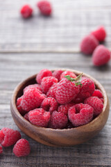 Fresh raspberry in a wooden bowl