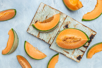 cantaloupe melon. whole and slice of japanese melons, orange melon with seeds on light background. place for text, top view