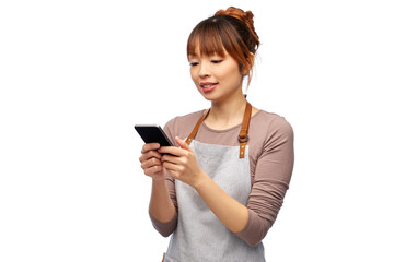 cooking, technology and people concept - happy smiling female chef or waitress in apron showing smartphone with empty screen over white background