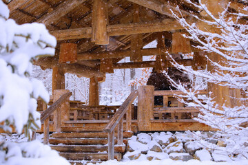 a wooden hut is like a gazebo in a winter snow-covered forest where it snows 