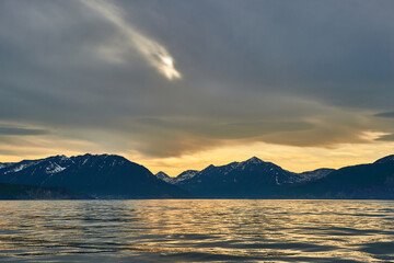 Fototapeta premium Sea sunset on the background of volcanoes and mountains. Kamchatka, Russia. Sea cruises and travel