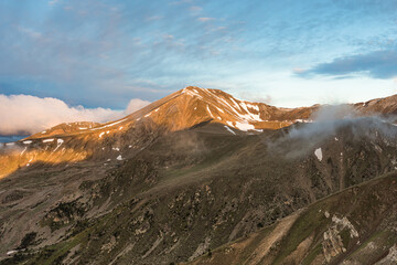 Golden sunlight over the peak (Peak of Bastiments, Pyrenees Mountains, Catalonia, Spain, Ulldeter)