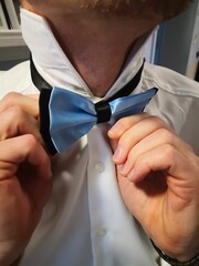 person adjusting tie
