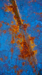bright blue painted steel surface with contrasting yellow rust coloured patches