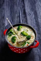 Broccoli cheese soup in a pot, top view