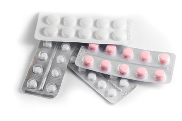 Close-up of a couple white pills or capsules on isolated white background.