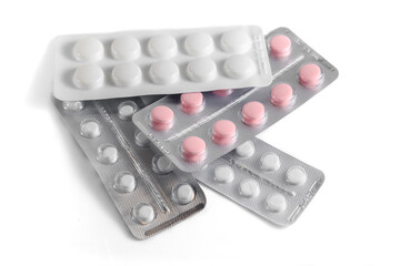 Close-up of a couple white pills or capsules on isolated white background.