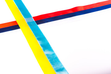 Ribbons colored of flags of Russia and Ukraine, laid out with a cross on a white background. isolated, copy space