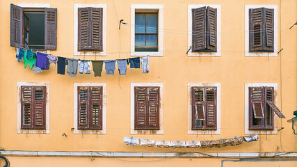 Picturesque typical Italian slum residential house with clothes hanging on laundry line