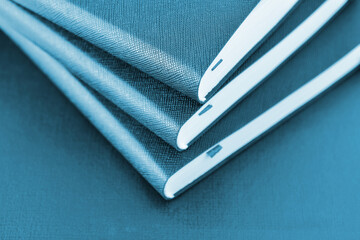 Three notebooks. Close-up of a part of the diaries. Tinting in dark blue.
