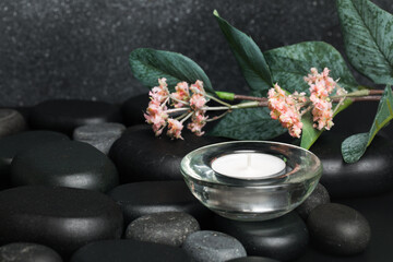 Obraz na płótnie Canvas Spa stones and candle on black background - Image