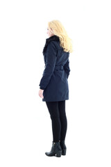 full length portrait of blonde woman wearing long winter coat. and casual clothes. standing pose, isolated on a white studio background.
