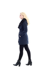 full length portrait of blonde woman wearing long winter coat. and casual clothes. standing pose, isolated on a white studio background.