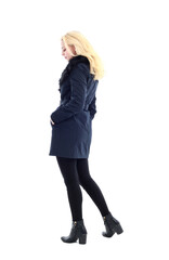 full length portrait of blonde woman wearing long winter coat. and casual clothes. standing pose, isolated on a white studio background.